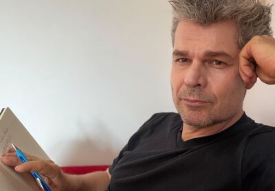 Nikolas Migut mit Notizbuch bei der Planung von Achterbahnleben